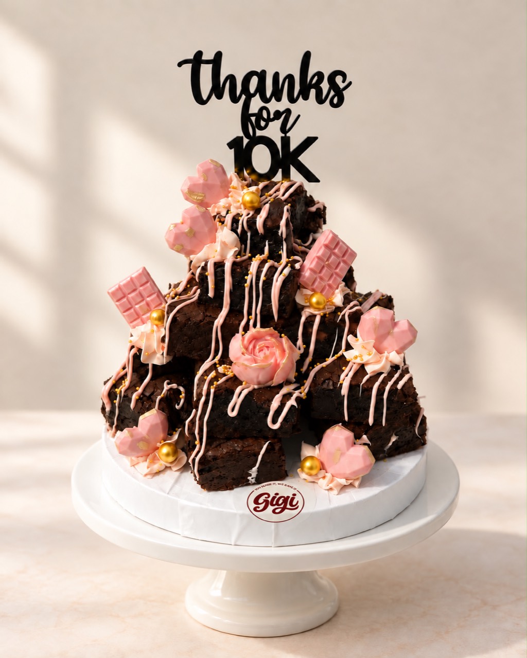 Gigi brownie tower with pink chocolate decorations and gold details