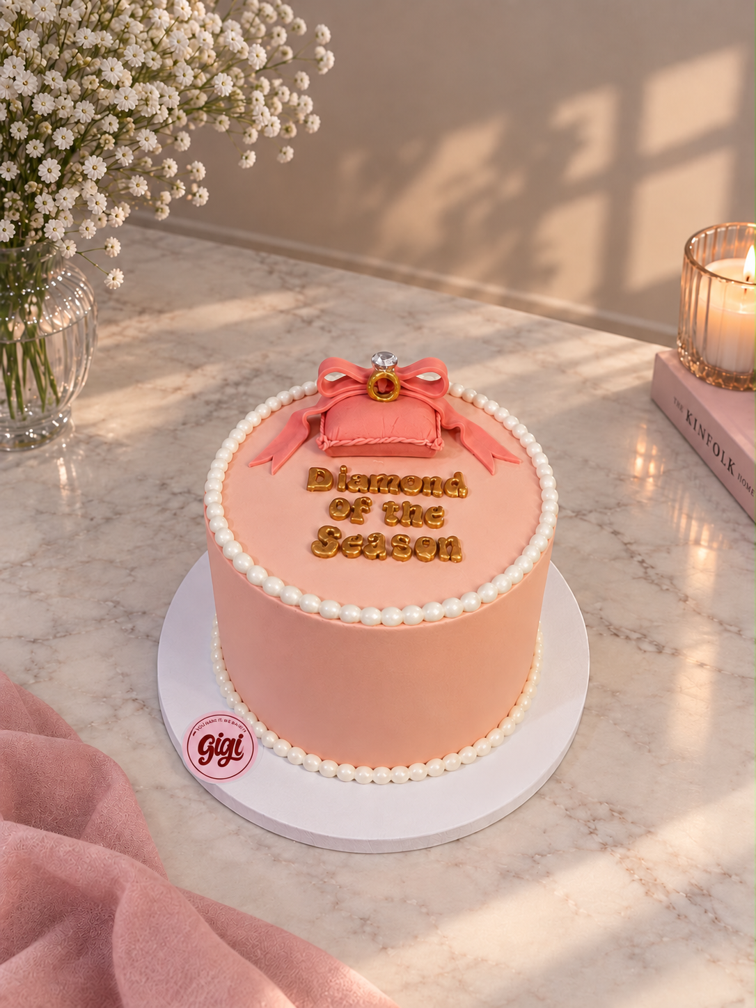 Peach celebration cake with pearls and a ring topper