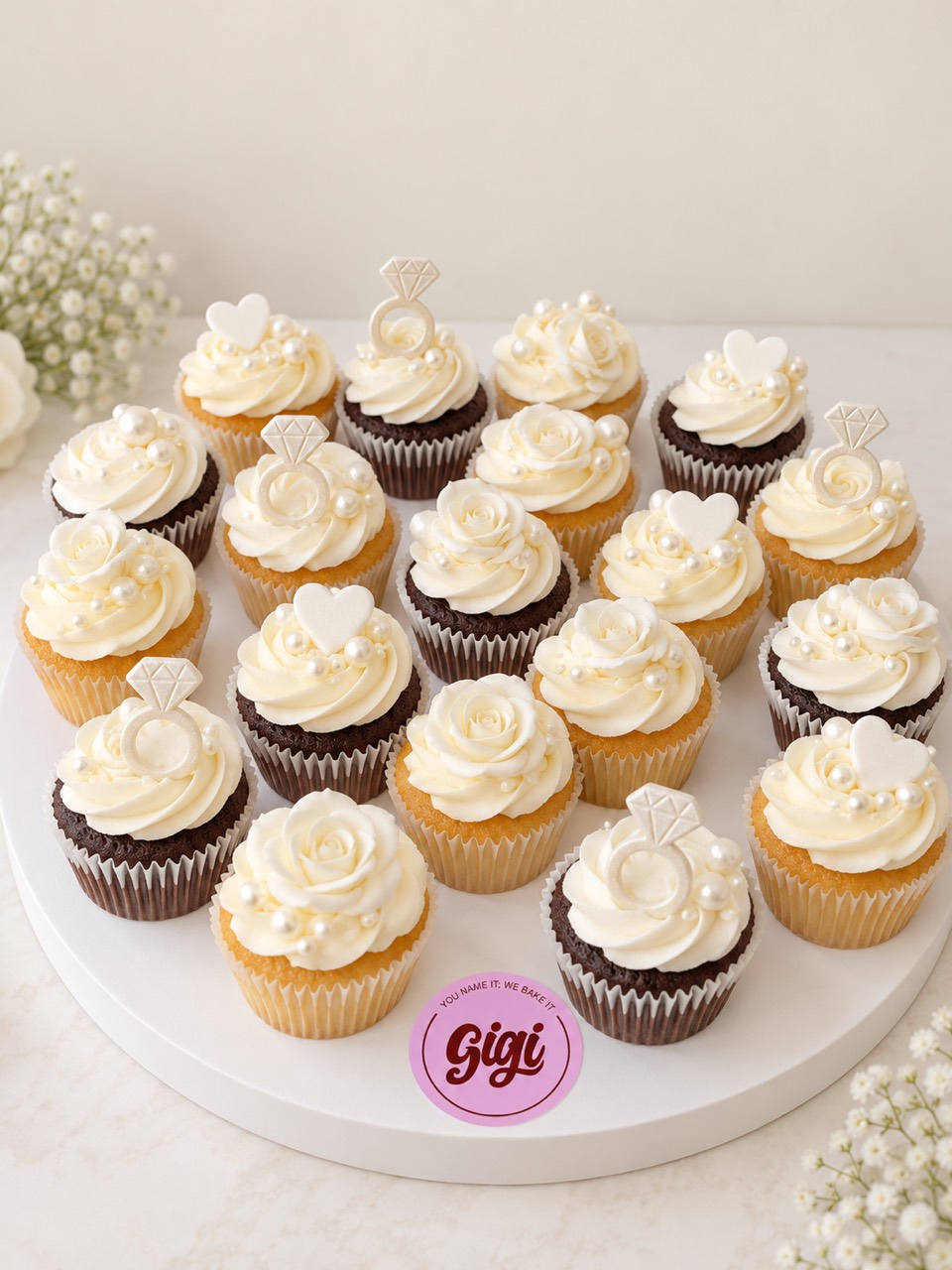 Engagement cupcakes with ivory roses and ring decorations