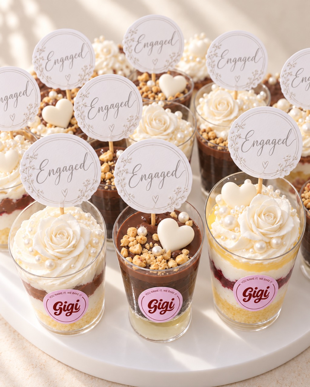 Layered engagement dessert cups with personalised toppers
