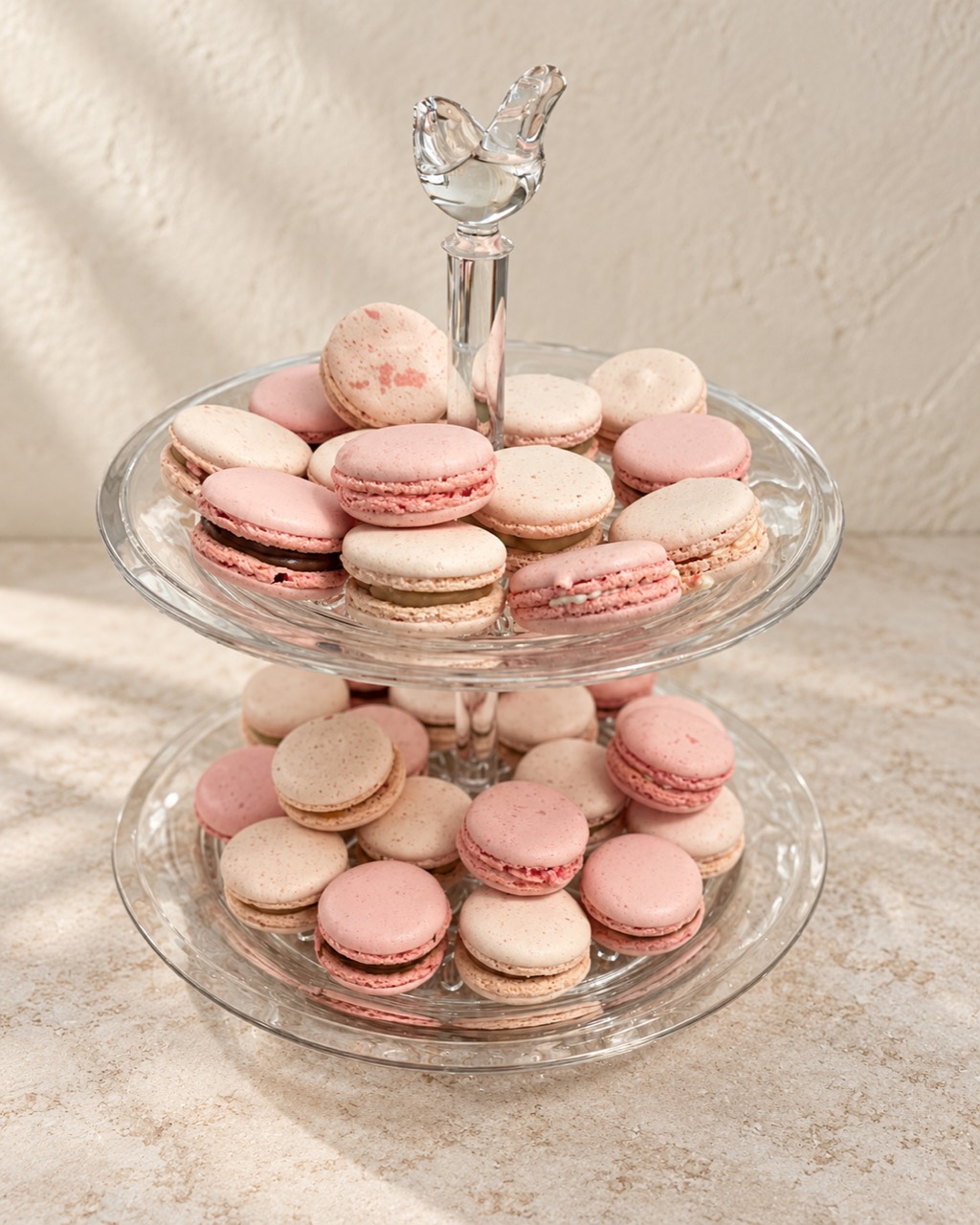 Pink and cream macarons on a glass stand
